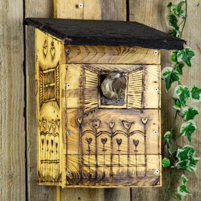 image of birdhouse carved with wood burner